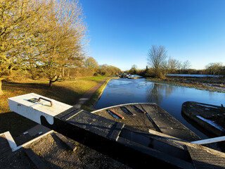 uk canal in winter with snow and frost