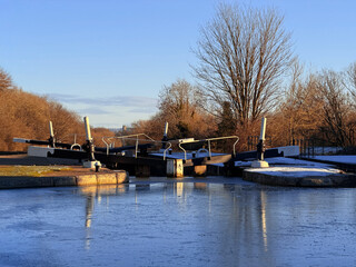 uk canal in winter with snow and frost