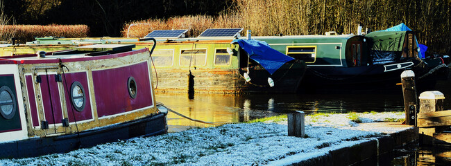 uk canal in winter with snow and frost