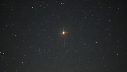Bright orange star with cross diffraction spikes shining against a deep night sky background filled with distant stars and galaxies.