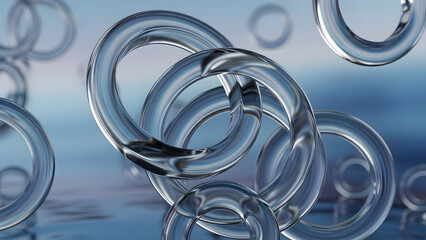 Clear glass rings floating on a reflective surface with a soft blue background.