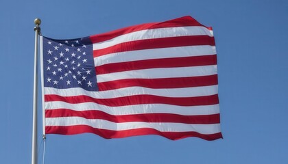 Fototapeta premium American Flag Waving Against Clear Blue Sky on Sunny Day with No Clouds in Background