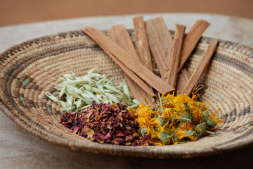 Ojo Caliente, New Mexico, United States.  Dried herbs placed on a flat Native American basket. 