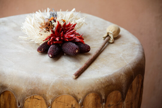 Ojo Caliente, New Mexico, United States.  Dried red corn and chili decor a top a Native American drum. 