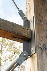 Bottom view of a wooden platform with metal diagonal links of the structure.