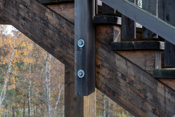 Wooden ladder beam with bolted connections in the inspection structure.
