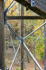 Diagonal metal pipes reinforcing the wooden supporting structure.