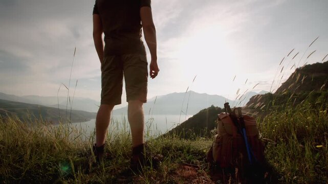 Camera gliding around traveler standing near tent under morning sun mountain valley below concept of openness inspiration balance gratitude and connection with wild freedom