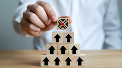 Goal achievement concept with wooden block pyramid and red bullseye target symbolizing success and progress