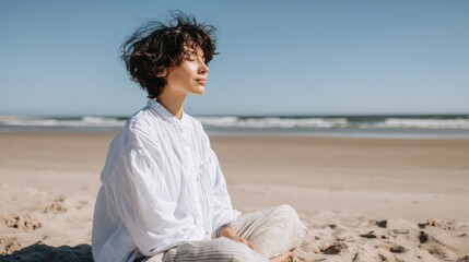 Young adult asian female meditating on beach in morning sun