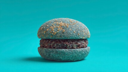 A vibrant shot of an unusual-colored burger on a matching background. The bread is sprinkled with sesame seeds, and the patty is a dark brown color