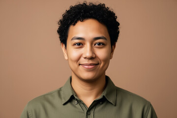 Inclusive professional headshot, warm taupe background.