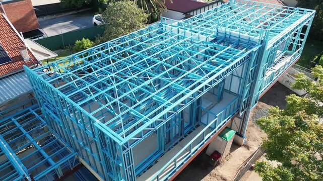 Steel frame house under construction, modern residential building site
