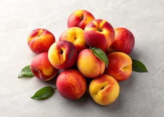 The peaches piled with vibrant red and yellow skin and fresh green leaves