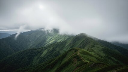 Dramatic mountain range landscape with lush green slopes and misty clouds, creating a serene and atmospheric natural backdrop for adventure and tranquility.