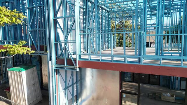 Steel frame house under construction, modern residential building site
