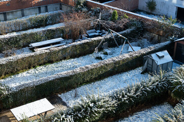 High angle view over snow covered backyards and rooftops in a residential area in Jette, Brussels Capital Region