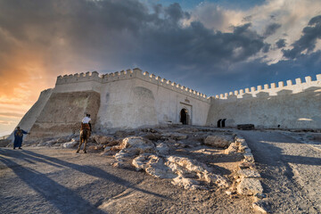 Sunset At Historic Fortress Gate With Rider On Horse Beside Rocky Shoreline, Agadir, Morocco