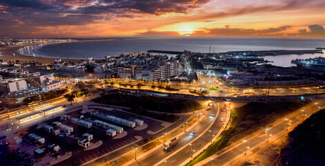Sunset Over Coastal City With Harbor Lights, Beach, and Busy Roadways, Agadir, Morocco