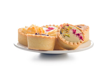 Sweet mini tartlets on plate  isolated on white background.