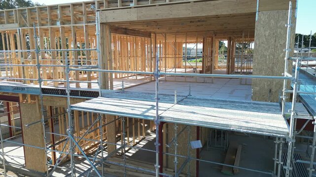 Wooden house frame under construction, timber structure residential building site
