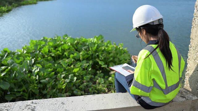Environmental engineers work at the water storage plant, check the pH of the water, check the quality of the water.