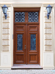 Ornate carved wooden door with glass and wrought iron