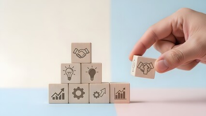 Building Blocks of Success Hand places partnership icon atop business strategy pyramid, representing collaboration, innovation, and growth for corporate development