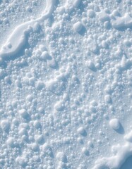 Close-Up of Freshly Fallen Snow with Bubbly Texture in Soft Natural Light for a Winter Background, Calm Seasonal Mood, and Copy Space.