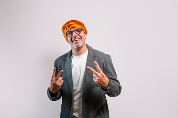 Man in orange wig making v sign smiling