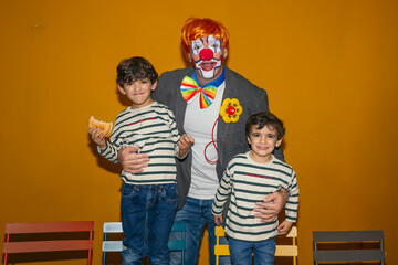 Clown celebrating birthday party with happy children