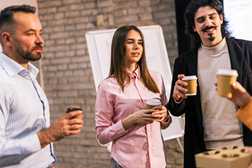 Coworkers Having Coffee Break Conversation in Modern Office