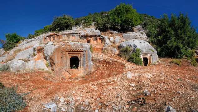 The ancient Lycian rock tombs of Demre (Myra) are carved into the red cliffs: facades with Doric columns and pilasters over terraces, a classic symbol of Lycian culture in Turkey