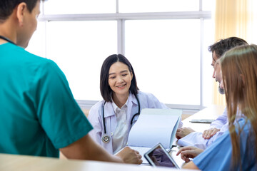 Team of diversity doctor and nurse is discussing and brainstorming over patient medical record after diagnosis for precise care plan with experienced senior physician specialist