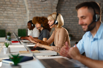 Female call center agent talking to customer during work in office
