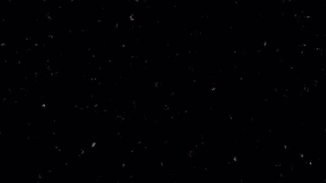 Noise, dirt, dust, scratches and grain on old damaged film surface. Old film look, tv signal with white bad interference, static noise background. Black background. 4K