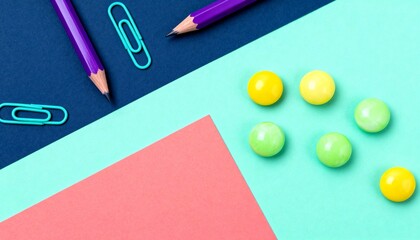 A minimalist flat lay of pencils, clips, and balls arranged geometrically on a deep blue background. Represents order, creativity, and modern office aesthetics.