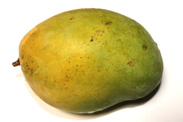Close-up shot of a ripe mango with yellow and green skin on a white background.