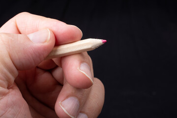 Hand holding colored pencils for creative idea and concept.