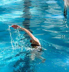 Senior Female Swimmer in an Indoor Pool Completing Laps for Exercise