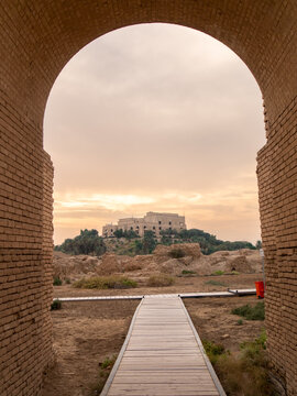 Saddam Hussein's abandoned palace in Ancient Babylon, in the distance, during sunset