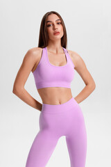 Athletic girl on the gray background. Fitness woman