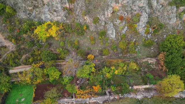 Aerial video reveal of Lin village on Lake Ohrid, showing terracotta rooftops, turquoise water, and the ancient basilica ruins on the peninsula.