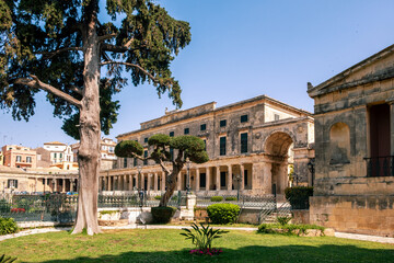 Obraz premium Historic neoclassical Palace of St. Michael and St. George in Corfu, Greece. A greek flag waving on the roof, clear blue sky