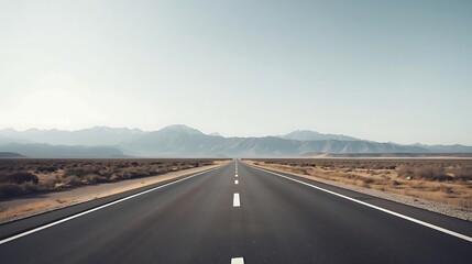 Long Asphalt Highway Stretching through Desert Mountain Valley