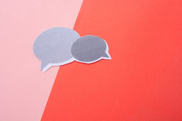 Mini speech bubbles cut out of paper in view