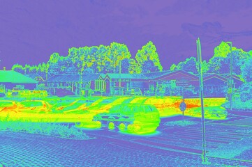 Thermal imaging showing cars and buildings in parking area