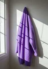 Cozy Purple Cardigan Hanging in Sunlight with Dramatic Window Shadows mockup