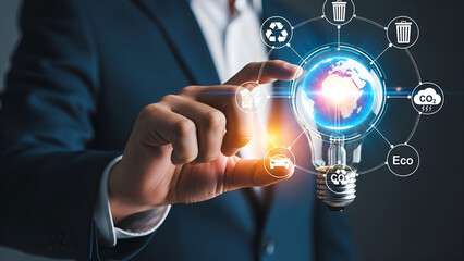 Businessman interacts with digital interface showing illuminated earth globe inside a lightbulb surrounded by sustainability icons for global conservation efforts