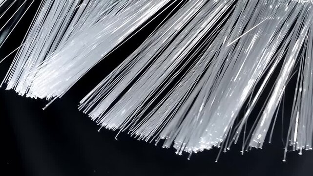 Close up of white decorative fringe trim with thin silky threads on black background